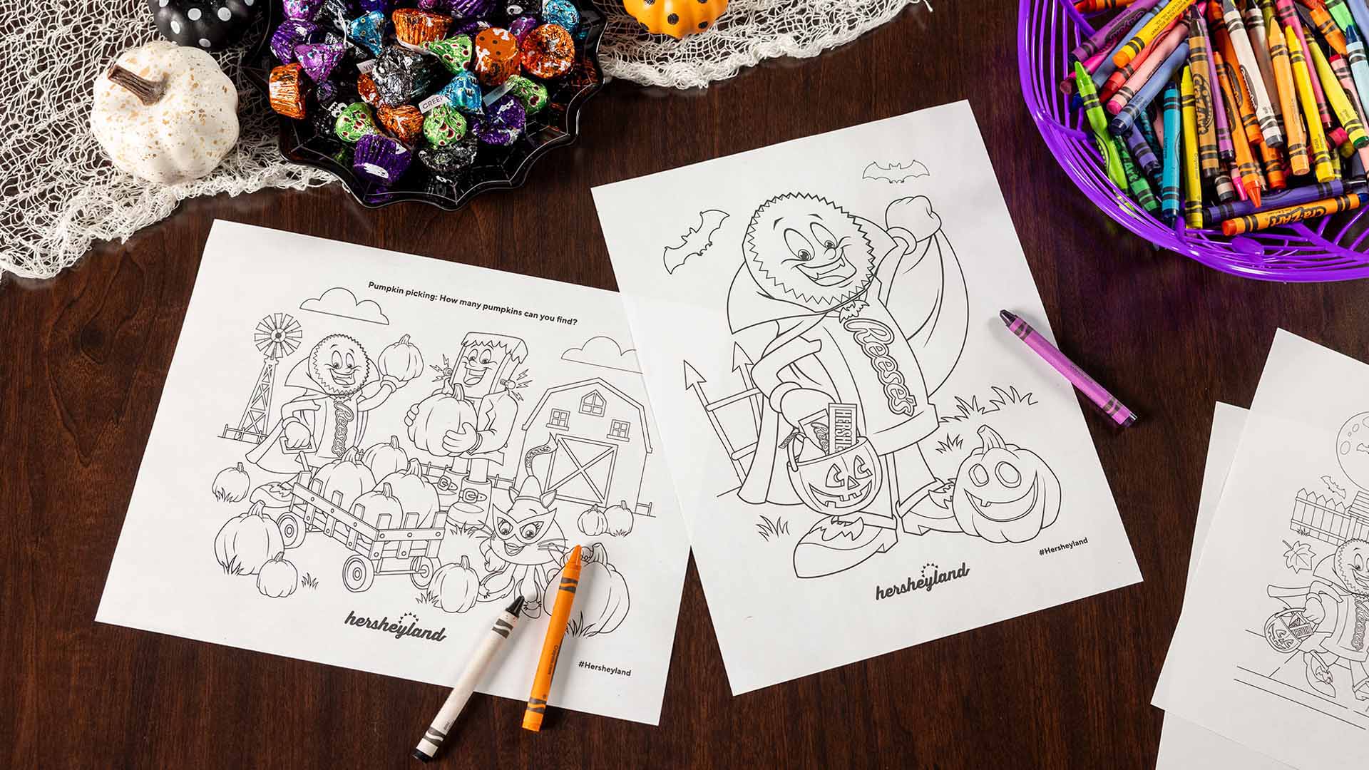 hershey halloween mascot coloring pages and crayons scattered across tabletop