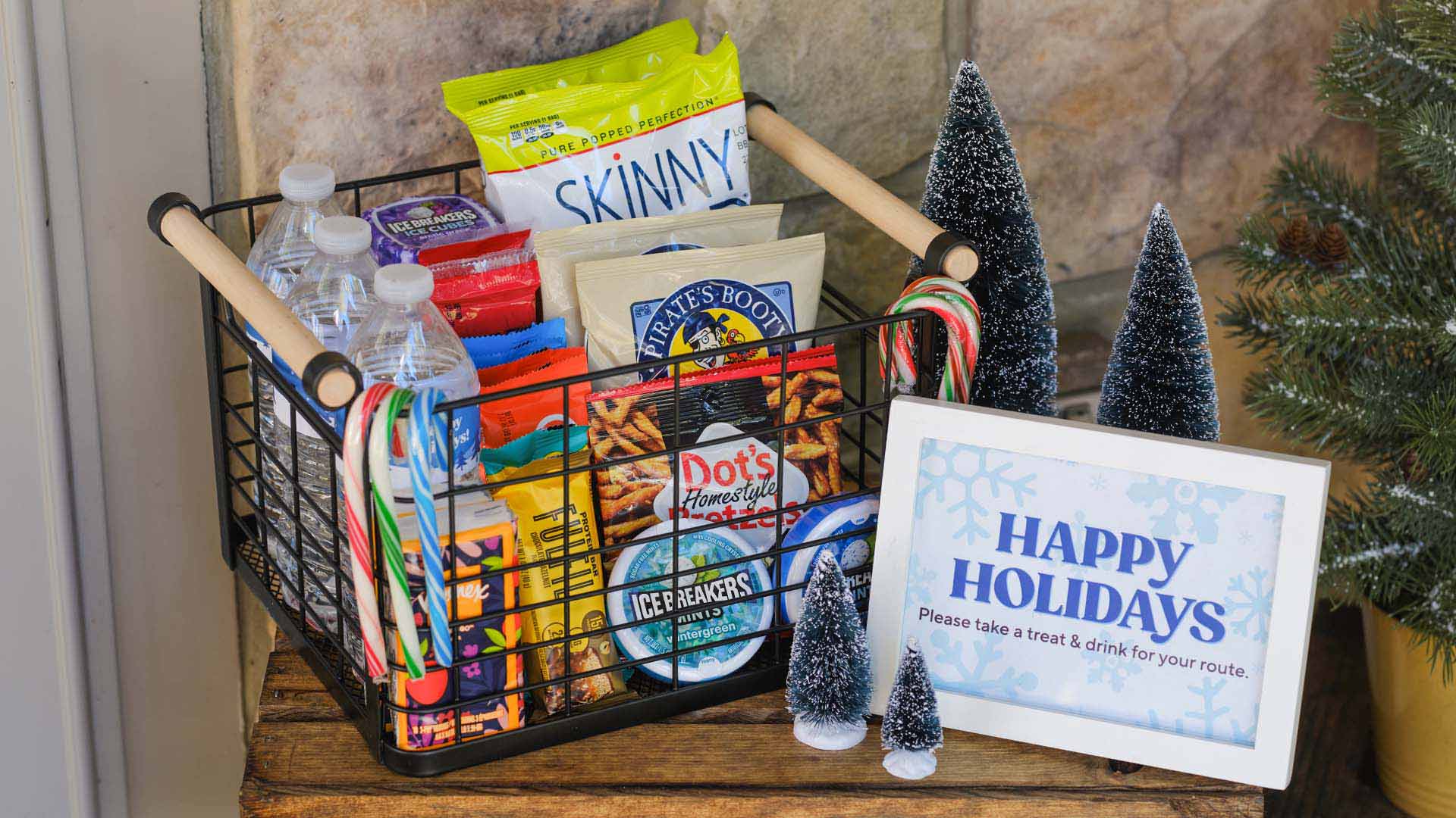 basket filled with assorted hersheys sweet and salty snacks, water bottles, and tissues