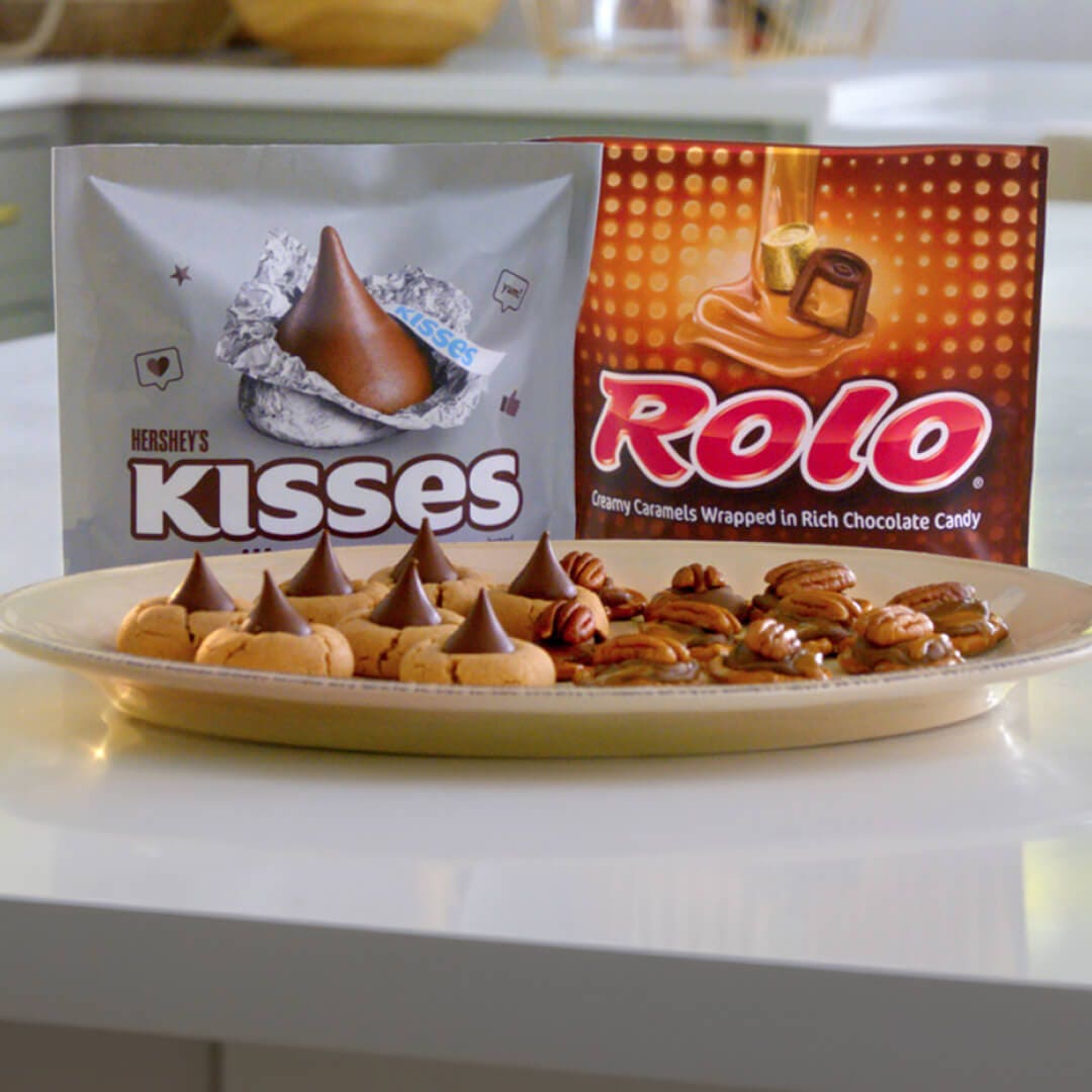 plate of hersheys kisses blossom cookies and rolo pretzel delights