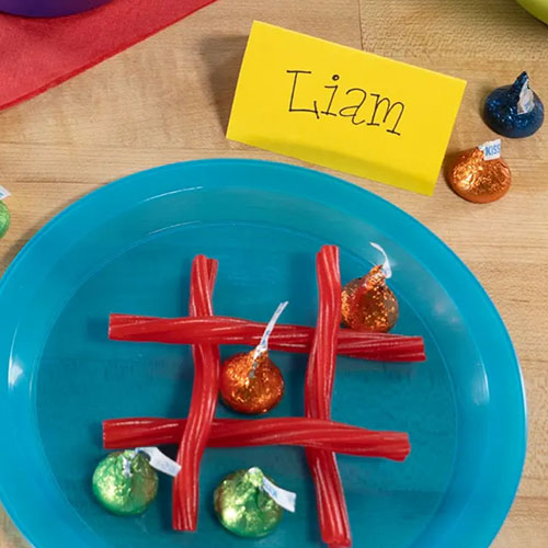 using assorted hersheys candy to create a tic tac toe board 